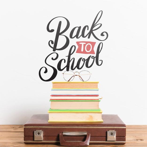 Front View Briefcase With Pile Of Books Psd