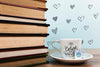 Front View Cup Of Coffee With Label And Pile Of Books Psd