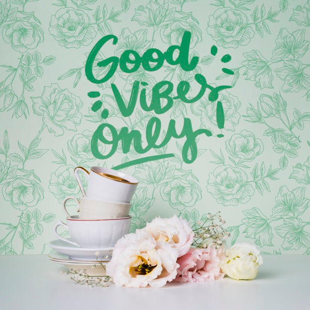 Front View Cups And Flowers With Motivational Quote Psd