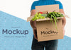 Front View Delivery Man Holding A Box With Different Vegetables Psd