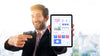 Front View Of Businessman Holding And Pointing At Tablet Psd