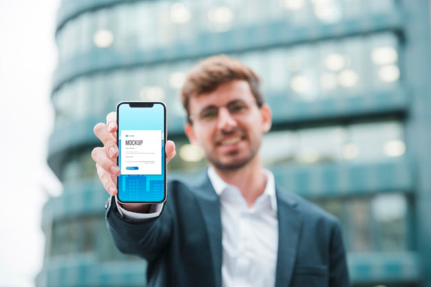 Front View Of Businessman Holding Smartphone Psd