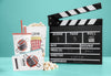 Front View Of Cinema Popcorn With Cup And Clapperboard Psd