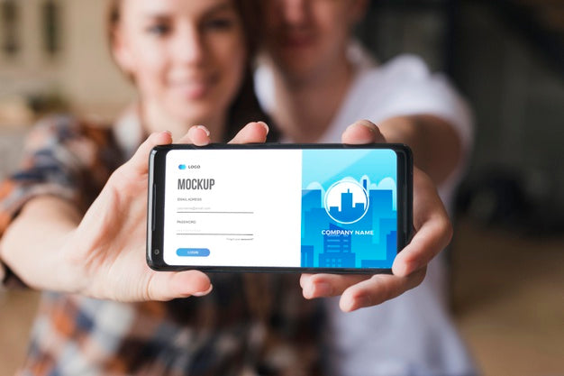 Front View Of Couple Holding A Smartphone Mock-Up Psd