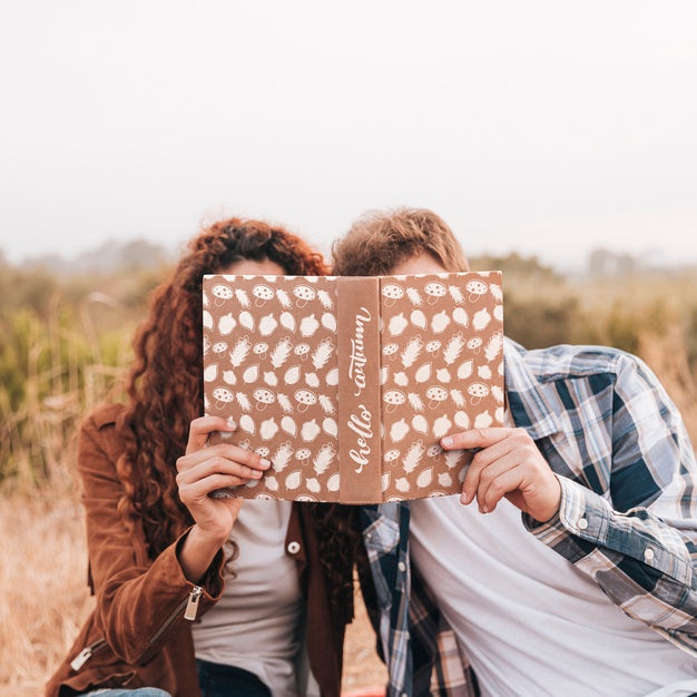 Front View Of Couple Looking In A Book Psd