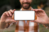 Front View Of Defocused Smiley Man Holding Smartphone While Camping Psd