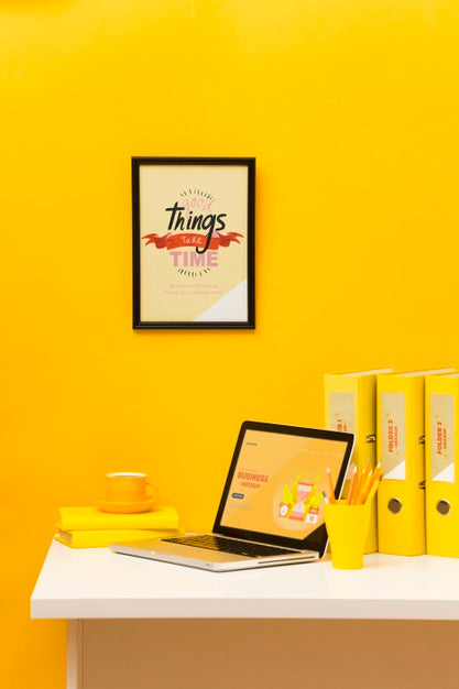 Front View Of Desk With Laptop And Frame Psd
