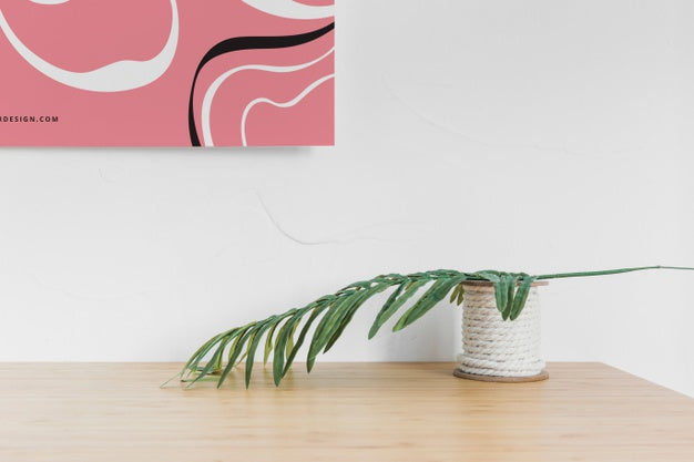 Front View Of Desk With Leaf And Poster Psd