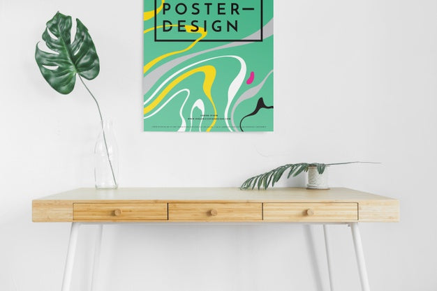 Front View Of Desk With Leaves And Poster Psd