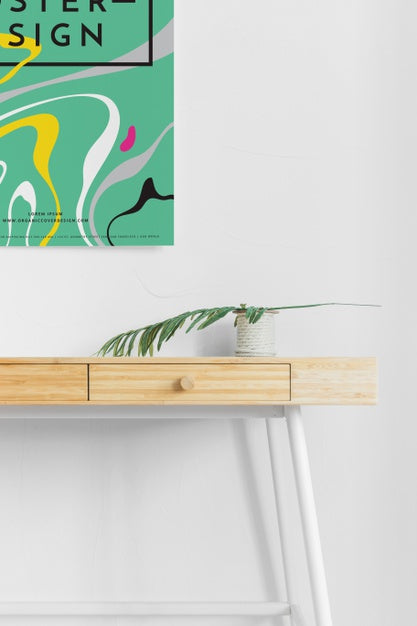 Front View Of Desk With Poster And Leaf Psd