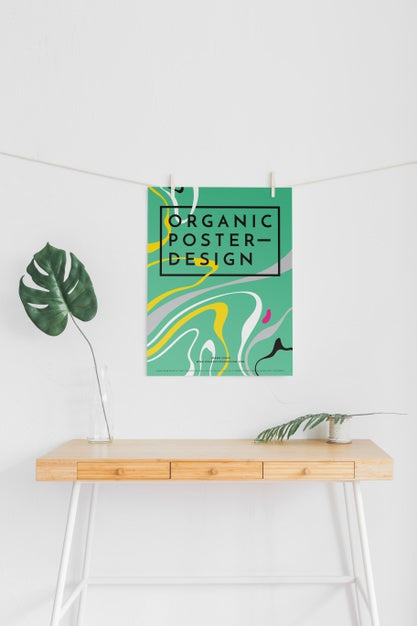 Front View Of Desk With Poster And Leaves Psd
