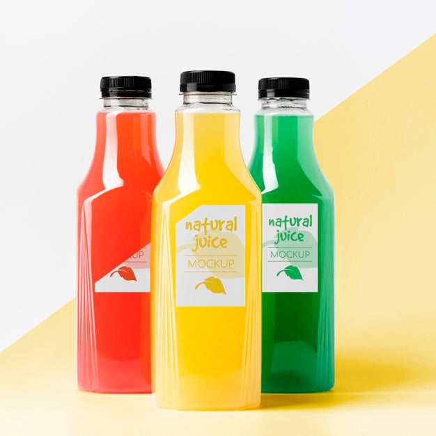 Front View Of Different Clear Juice Bottles With Caps Psd