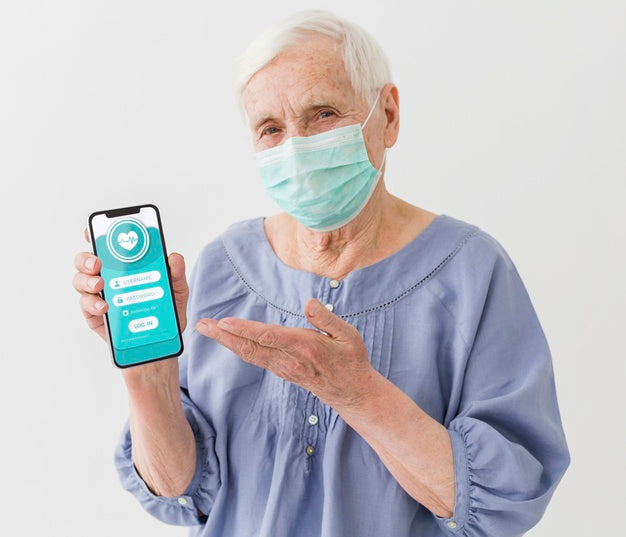 Front View Of Elder Woman With Medical Mask Holding Smartphone Psd