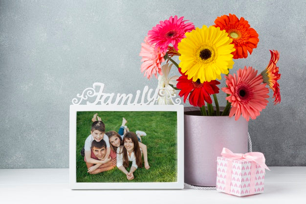 Front View Of Flowers On With Frame On Table Psd
