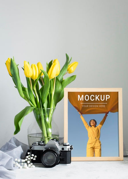 Front View Of Frame With Bouquet Of Tulips In Vase And Camera Psd