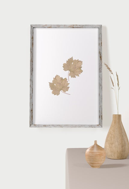 Front View Of Frame With Leaves On Wall And Vases Psd