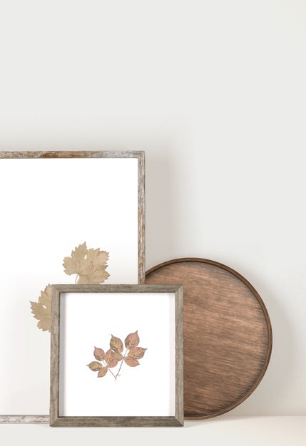 Front View Of Frames With Leaves And Wooden Tray Psd