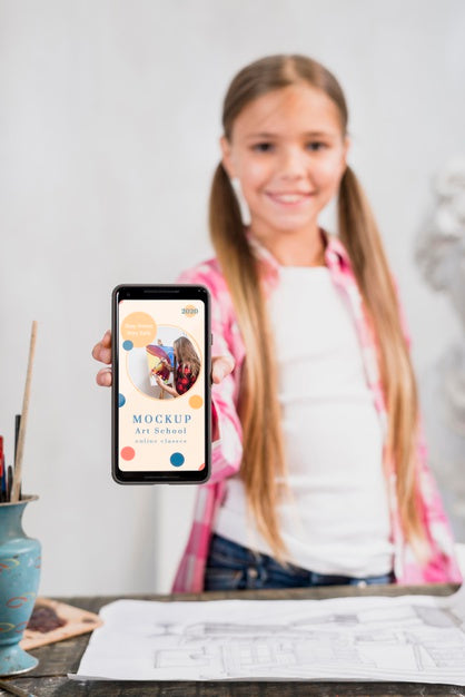 Front View Of Girl Artist Holding Smartphone Psd
