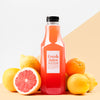 Front View Of Glass Juice Bottle With Grapefruit And Lemons Psd