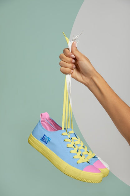 Front View Of Hand Held Sneakers Psd
