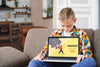Front View Of Kid On Couch Holding Laptop Psd
