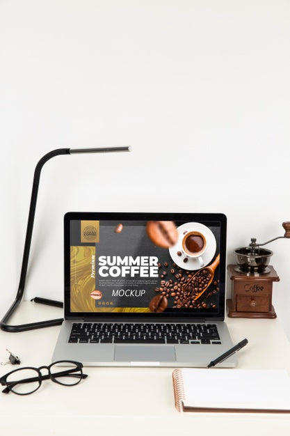 Front View Of Laptop On Desk With Lamp And Glasses Psd