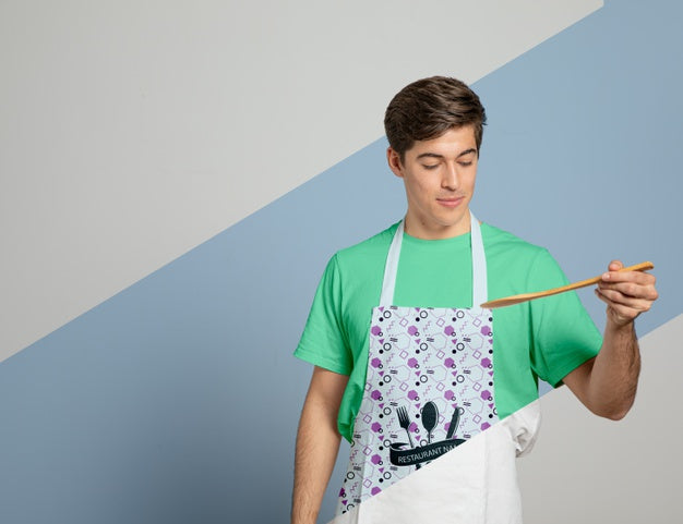 Front View Of Man In Apron Holding Wooden Spoon Psd