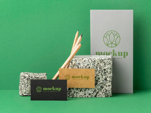 Front View Of Paper Stationery With Rocks Psd