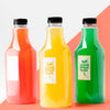 Front View Of Selection Of Juice Bottles With Caps Psd