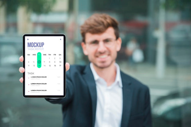 Front View Of Smiley Businessman Holding Tablet Psd