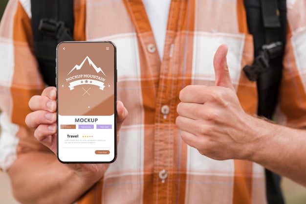 Front View Of Smiley Man Holding Smartphone And Giving Thumbs Up While Camping Psd