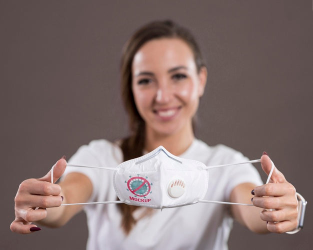 Front View Of Smiley Woman Holding A Mask Psd