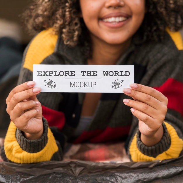 Front View Of Smiley Woman Holding A Piece Of Paper While Camping Psd