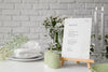 Front View Of Table Arrangement With Spring Menu Mock-Up And Candles Psd