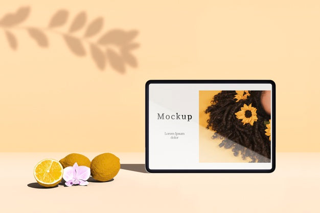 Front View Of Tablet With Citrus Fruit And Shadow Psd