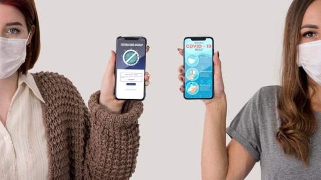 Front View Of Two Women With Masks Holding Smartphones Psd