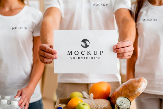 Front View Of Volunteers With Medical Masks Holding Blank Paper Psd