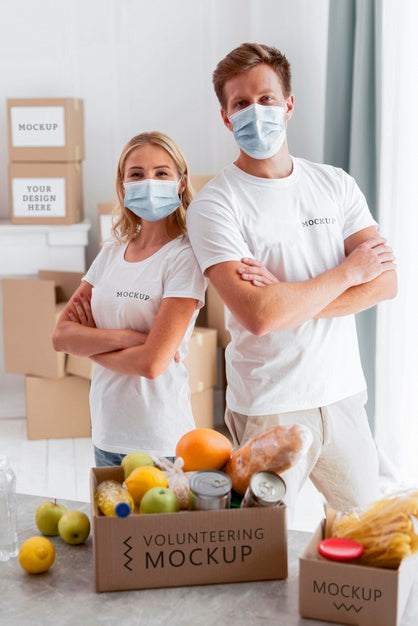 Front View Of Volunteers With Medical Masks Posing With Donation Boxes Psd