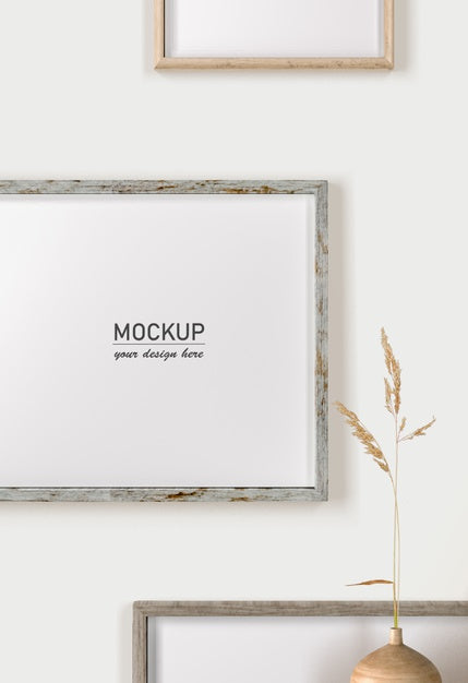 Front View Of Wall Decoration With Frames And Vase Psd