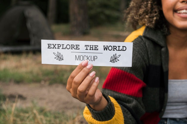 Front View Of Woman Holding A Piece Of Paper While Camping Psd