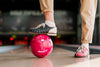 Front View Of Woman Holding Leg On Bowling Ball Psd