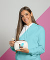 Front View Of Woman In Hoodie Holding Make-Up Pouch Psd