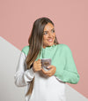 Front View Of Woman In Hoodie Holding Mug Psd