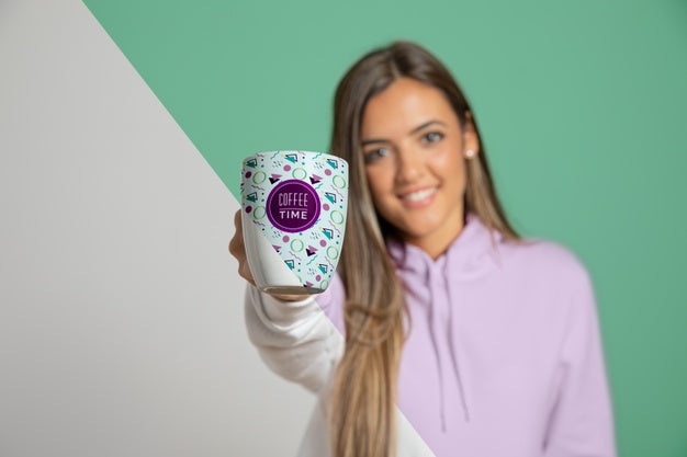 Front View Of Woman In Hoodie Holding Up Mug Psd