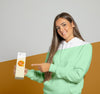 Front View Of Woman In Hoodie Pointing At Juice Carton Psd
