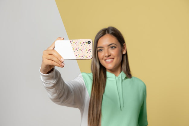 Front View Of Woman In Hoodie Taking Selfie With Smartphone Psd