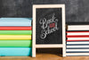 Front View Pile Of Books With Chalkboard Psd