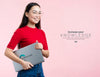Front View Woman Holding A Mock-Up Ad And Laptop Psd