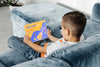 Full Shot Kid On Couch With Laptop Psd