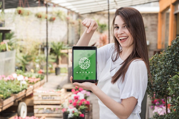 Girl Holding Tablet Mockup With Gardening Concept Psd